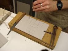 Punching holes to take the cords.