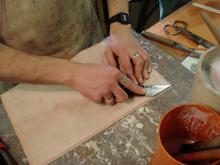 Paring the leather.