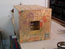 Large display case covered with dutch gilt paper.