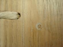 Detail showing pegs and cords cut flush with board