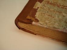 New leather spine going under the remains of the original spine.