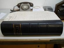 Large half leather binding, calf with morocco label, vellum manuscript deed on sides.